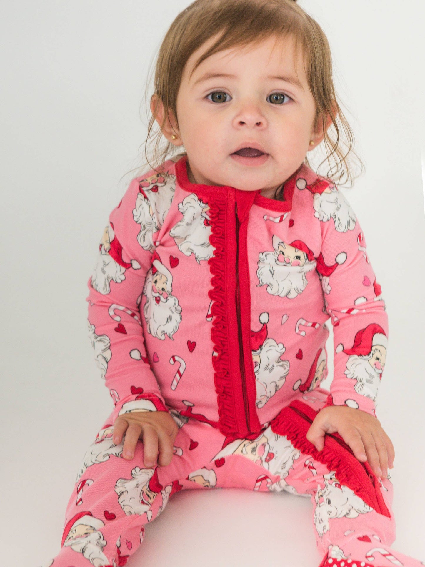 RuffleButts SoftSnooze™ Baby Girls Cotton Modal Pink Santa Joy Footed Ruffle One Piece Pajama