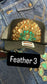 BLACK FEATHER TRUCKER HAT